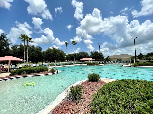 community pool featuring a patio and fence