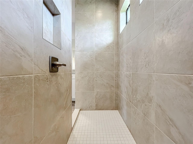 bathroom with a tile shower