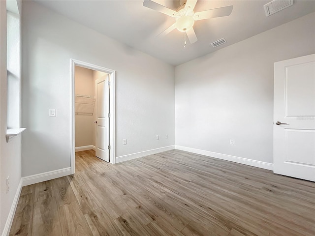 unfurnished room featuring ceiling fan and light hardwood / wood-style floors