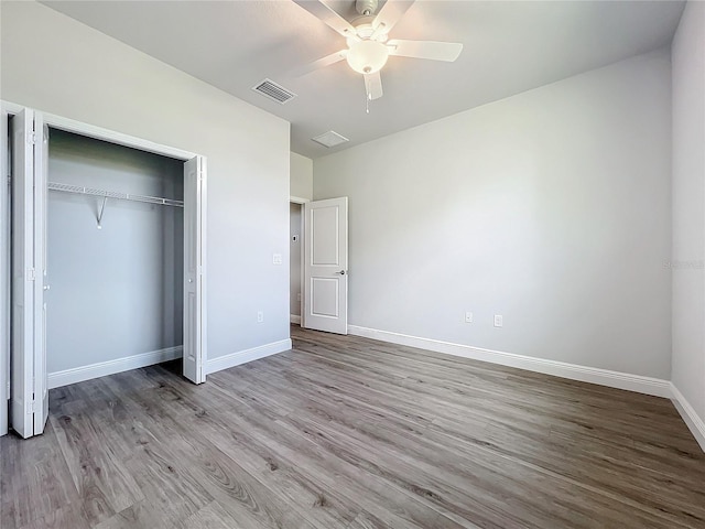 unfurnished bedroom with ceiling fan, a closet, and light hardwood / wood-style flooring