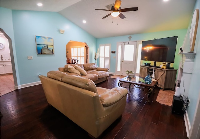 living room featuring hardwood / wood-style floors, vaulted ceiling, and ceiling fan