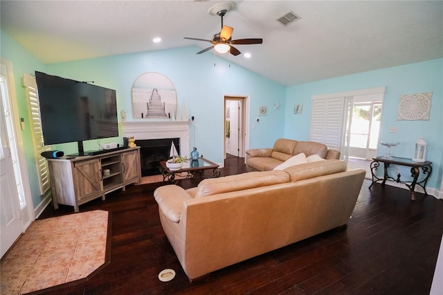 living room featuring ceiling fan, dark wood-type flooring, and vaulted ceiling