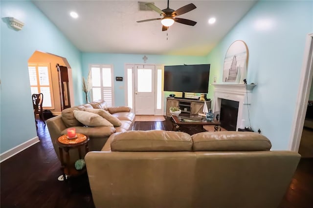 living room featuring ceiling fan, dark hardwood / wood-style flooring, and vaulted ceiling