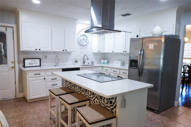 kitchen featuring island exhaust hood, white cabinets, stainless steel fridge with ice dispenser, a kitchen island, and a breakfast bar area