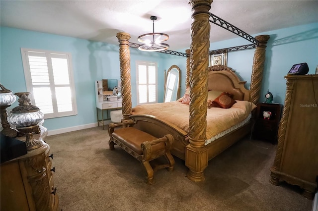 bedroom with a chandelier and dark carpet