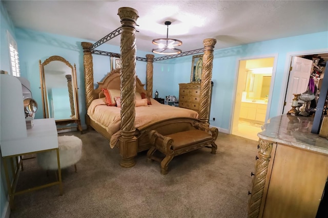 bedroom featuring connected bathroom and dark carpet