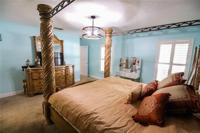 bedroom with carpet, a textured ceiling, and a notable chandelier