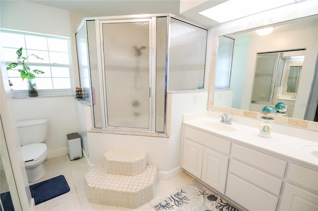 bathroom featuring tile patterned flooring, vanity, toilet, and a shower with door