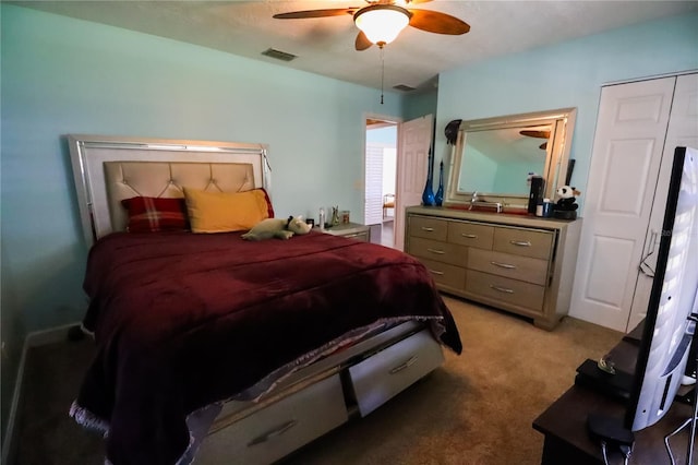 carpeted bedroom with a closet and ceiling fan