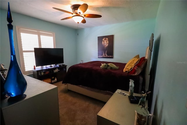 bedroom featuring dark carpet and ceiling fan