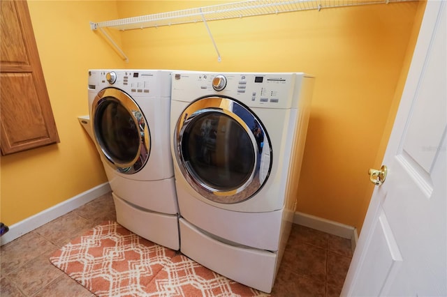 clothes washing area with light tile patterned floors and washing machine and clothes dryer