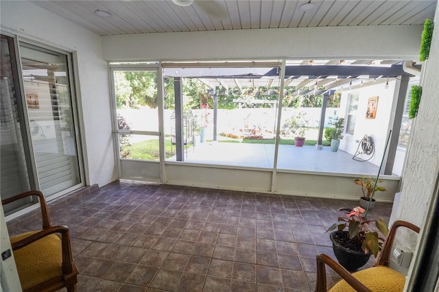 unfurnished sunroom with wooden ceiling