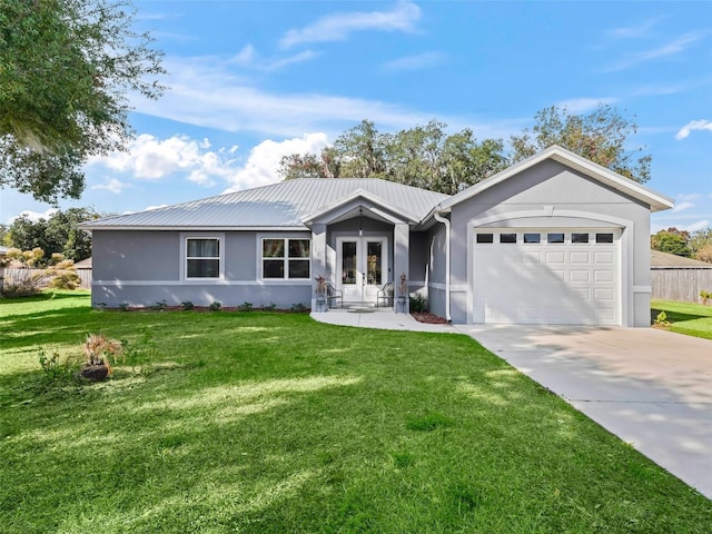 ranch-style house featuring french doors, a front yard, and a garage