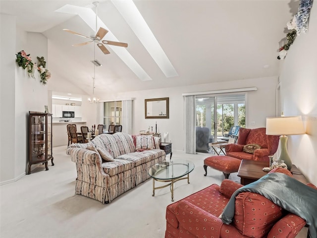 carpeted living room with ceiling fan and high vaulted ceiling