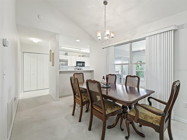 dining area with a notable chandelier, light colored carpet, and lofted ceiling