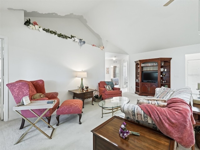 living room featuring high vaulted ceiling and light colored carpet