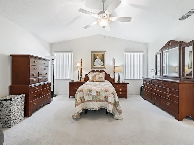 bedroom featuring light carpet, vaulted ceiling, and ceiling fan