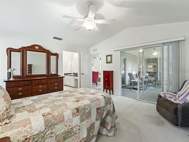 carpeted bedroom with ceiling fan, vaulted ceiling, access to outside, and ensuite bath