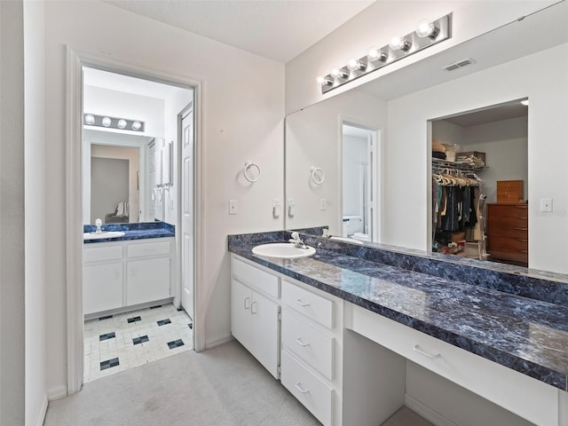 bathroom featuring tile patterned flooring and vanity