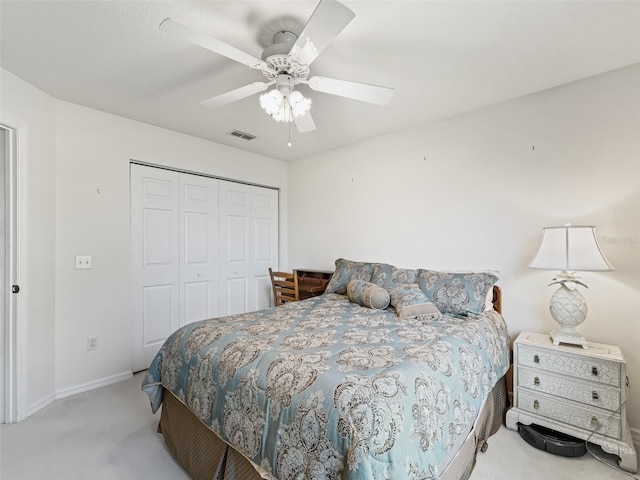 carpeted bedroom featuring a closet and ceiling fan