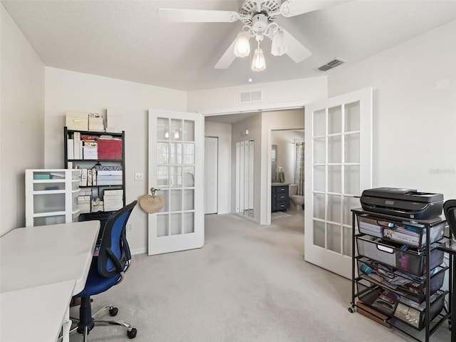 office area featuring ceiling fan, french doors, and carpet