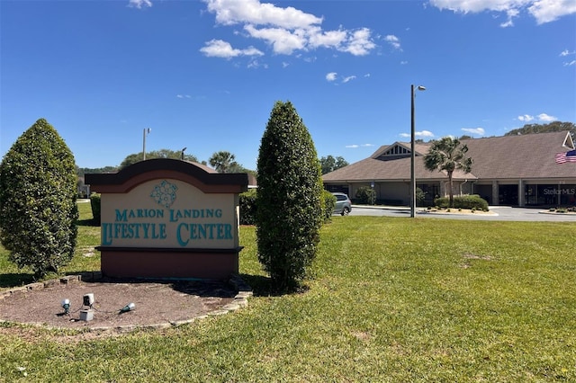 community sign featuring a lawn