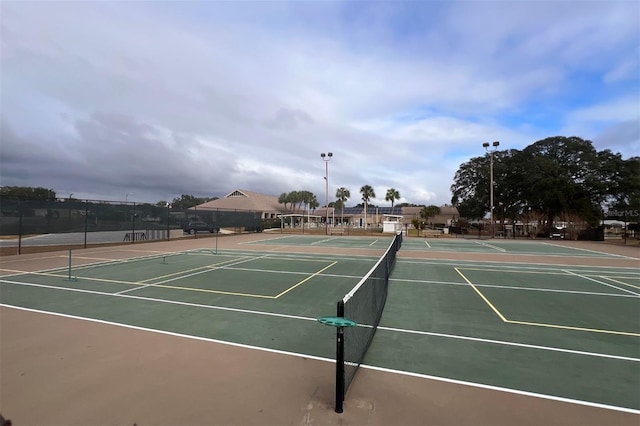 view of tennis court featuring basketball hoop