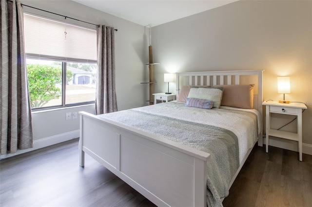 bedroom with dark wood-type flooring