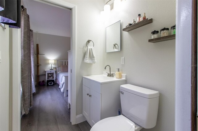 bathroom featuring hardwood / wood-style floors, vanity, and toilet