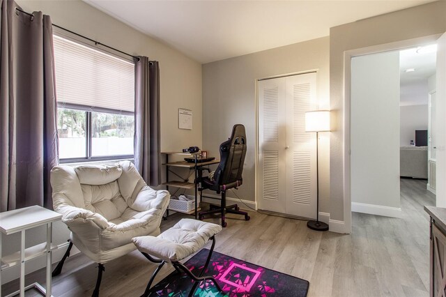 home office with light hardwood / wood-style flooring