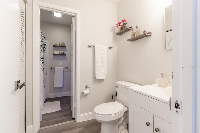 bathroom featuring hardwood / wood-style floors, vanity, and toilet