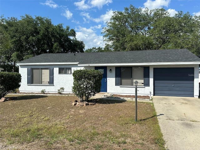 single story home featuring a garage, a front lawn, stucco siding, and driveway