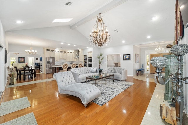 living room featuring light wood-type flooring and lofted ceiling with skylight