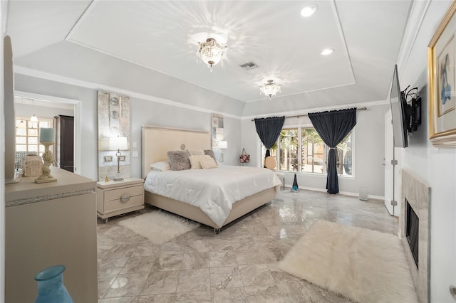 bedroom featuring a tray ceiling and crown molding