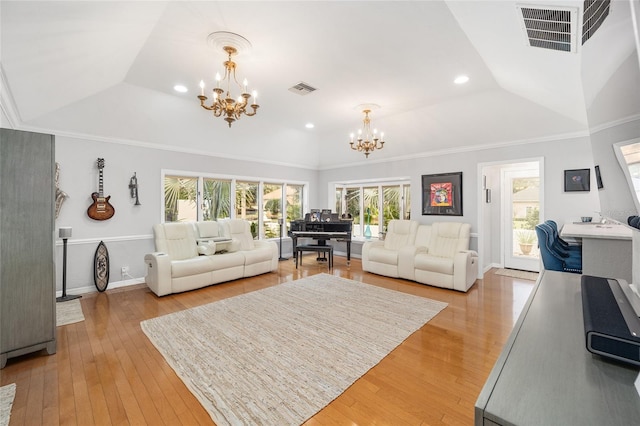 living room with a notable chandelier, crown molding, and light hardwood / wood-style flooring