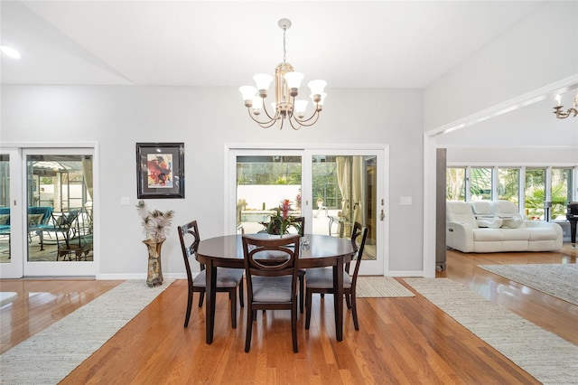 dining room featuring a chandelier, hardwood / wood-style floors, and a wealth of natural light