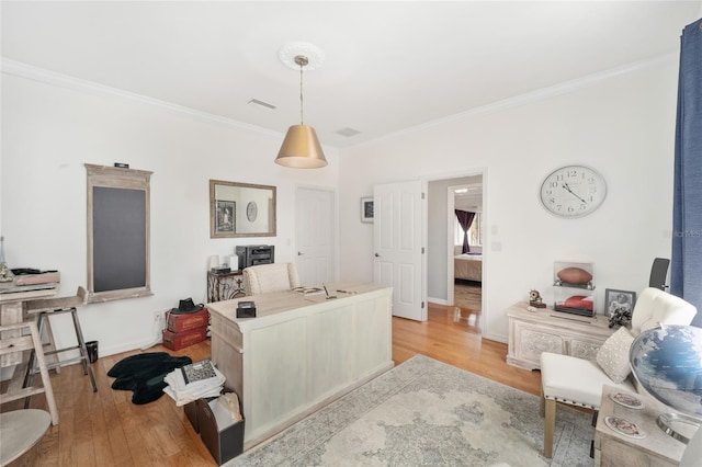 office featuring light hardwood / wood-style floors and ornamental molding