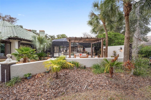 exterior space featuring an outdoor hangout area, glass enclosure, and a pergola