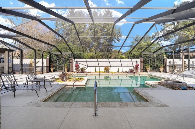 view of swimming pool featuring glass enclosure and a patio