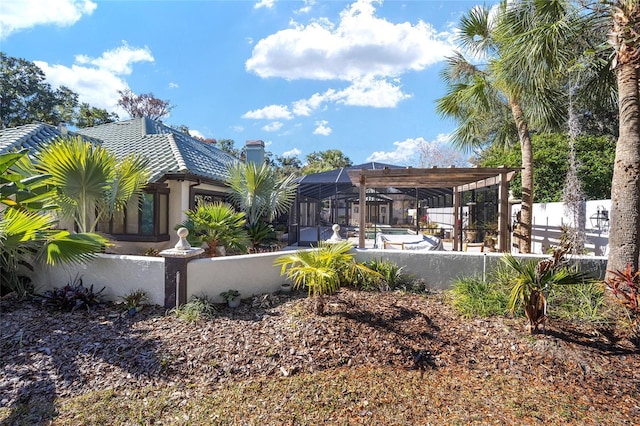 view of yard featuring a lanai and a pergola