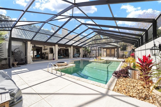 view of pool featuring ceiling fan, a storage unit, a lanai, and a patio