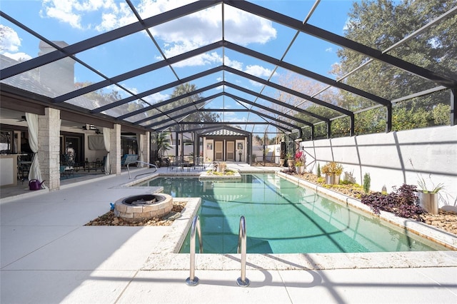 view of pool with a lanai, ceiling fan, and a patio area