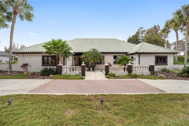 mediterranean / spanish-style home with a front yard