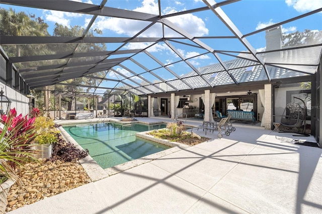pool featuring a patio, ceiling fan, a jacuzzi, and glass enclosure