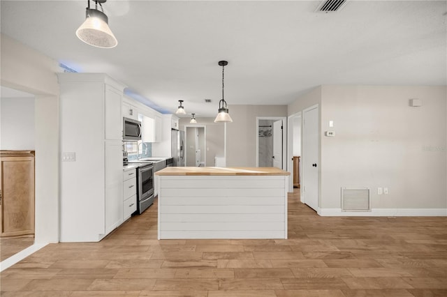 kitchen featuring light hardwood / wood-style floors, a center island, white cabinetry, and stainless steel appliances