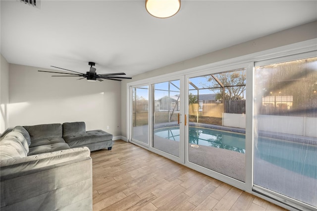 living room featuring ceiling fan and light hardwood / wood-style flooring