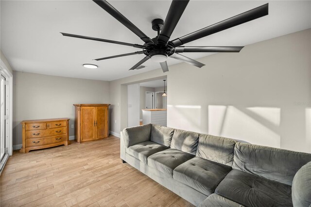 living room featuring light hardwood / wood-style flooring and ceiling fan