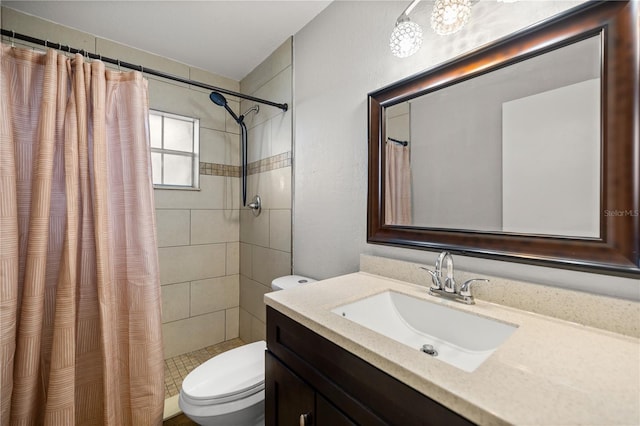 bathroom with vanity, toilet, and walk in shower