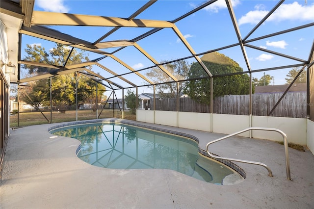 view of swimming pool with a patio area and a lanai