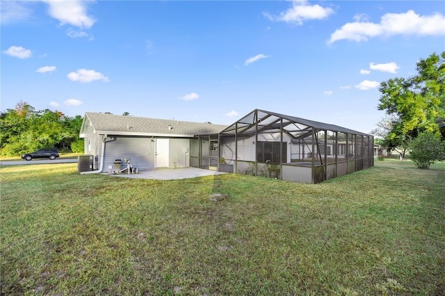 back of house featuring a lanai, a yard, a patio, and central air condition unit